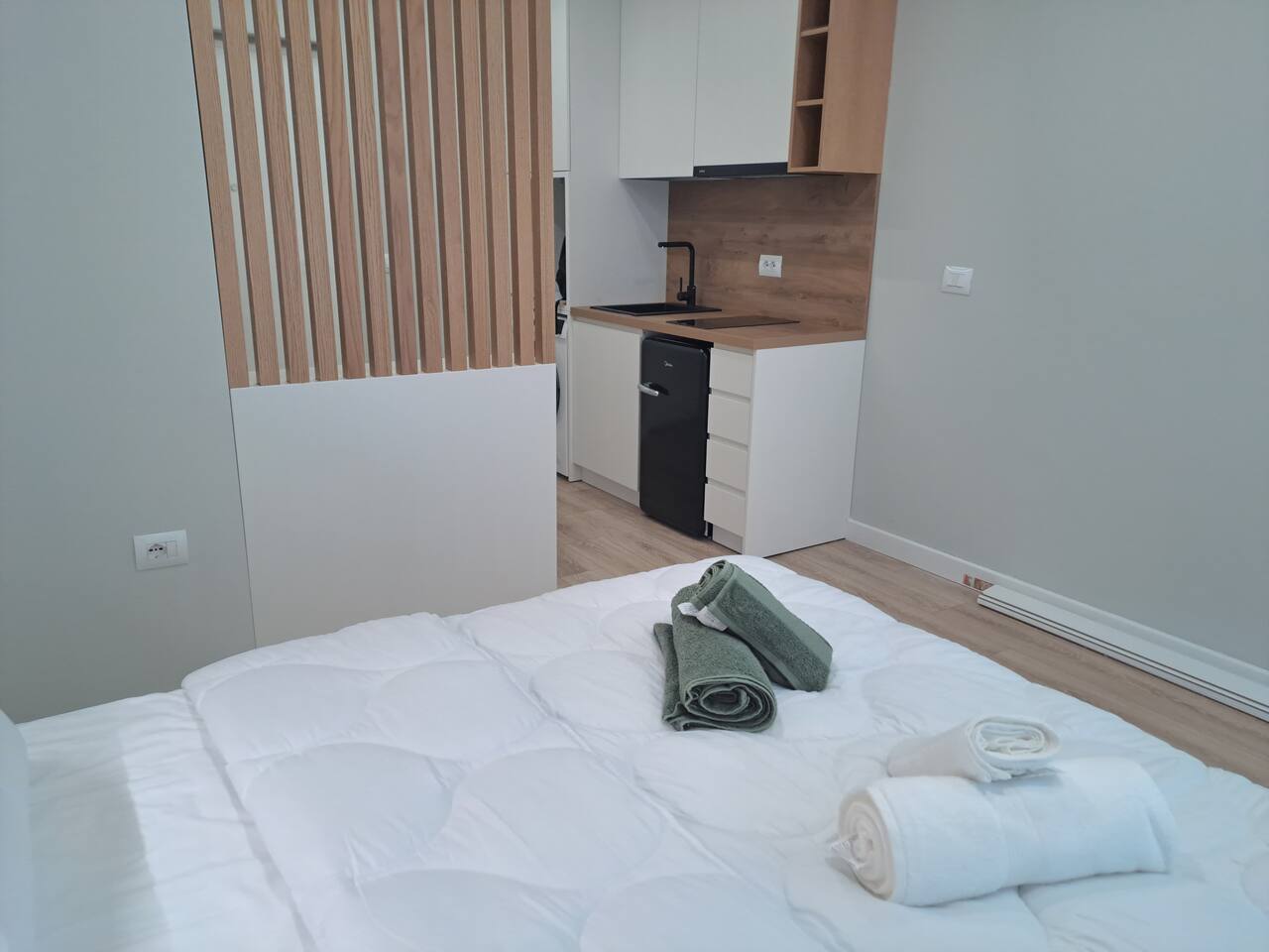 Kitchen area with modern appliances and wood accents