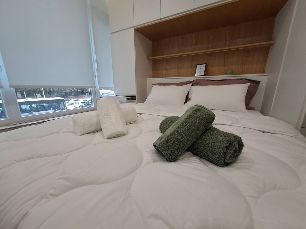 Comfortable bed with fresh towels and natural light